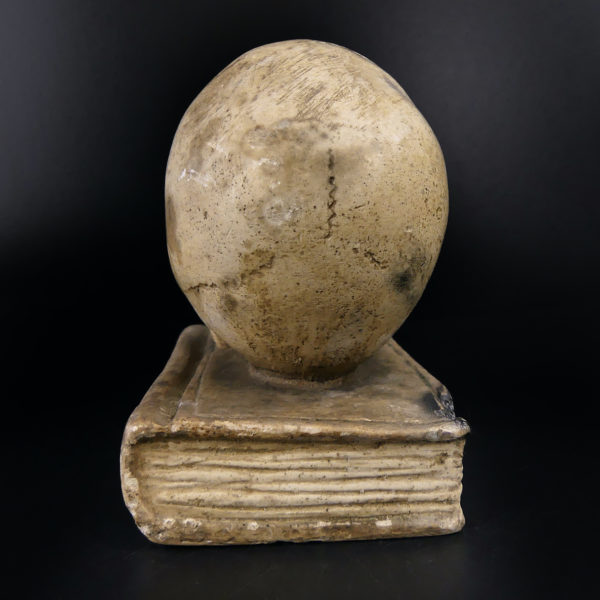 Petit crâne sur vieux livre relié en plâtre patiné Vanité Memento mori (dos)